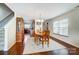 Inviting dining room featuring hardwood floors, modern light fixture, and decoratively patterned area rug at 309 River Clay Rd, Fort Mill, SC 29708