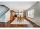Inviting dining room featuring hardwood floors, modern light fixture, and decoratively patterned area rug at 309 River Clay Rd, Fort Mill, SC 29708