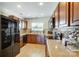 Spacious kitchen features stainless steel appliances, wooden cabinets, tile backsplash, and light counters at 309 River Clay Rd, Fort Mill, SC 29708