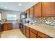 Spacious kitchen features stainless steel appliances, wooden cabinets, tile backsplash, and light counters at 309 River Clay Rd, Fort Mill, SC 29708