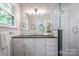 Elegant bathroom with white cabinets, black countertops, and modern subway tile at 3524 Johnny Cake Ln, Charlotte, NC 28226