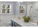 Bathroom features double sink vanity, tiled walls, and natural light at 3524 Johnny Cake Ln, Charlotte, NC 28226