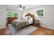 Comfortable bedroom with a bed, bedside tables, hardwood flooring, and large windows at 3524 Johnny Cake Ln, Charlotte, NC 28226
