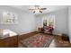 Open bedroom with natural light, wooden floors, and a vintage rug at 3524 Johnny Cake Ln, Charlotte, NC 28226