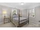 Traditional bedroom with a four-poster bed, two windows, and neutral paint at 3524 Johnny Cake Ln, Charlotte, NC 28226