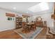 Dining area with skylight, a china cabinet, wood floors, and a table with seating for four at 3524 Johnny Cake Ln, Charlotte, NC 28226