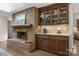 Brick fireplace with a wooden mantle and cabinets at 3524 Johnny Cake Ln, Charlotte, NC 28226