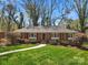 Charming brick home with a well-manicured lawn and mature trees creating a lovely curb appeal at 3524 Johnny Cake Ln, Charlotte, NC 28226