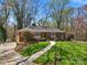 Attractive brick home with a green lawn, landscaping, and a concrete walkway leading to the front door at 3524 Johnny Cake Ln, Charlotte, NC 28226