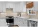 White cabinets, subway tile backsplash, and stainless steel appliances in the kitchen at 3524 Johnny Cake Ln, Charlotte, NC 28226