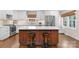 Kitchen featuring a center island with seating, white cabinets, modern appliances, and stone countertops at 3524 Johnny Cake Ln, Charlotte, NC 28226