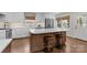 Kitchen island with seating, quartz countertops, and modern stainless steel appliances at 3524 Johnny Cake Ln, Charlotte, NC 28226