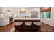Beautiful kitchen with a large island, white cabinets, stainless steel appliances, and hardwood floors at 3524 Johnny Cake Ln, Charlotte, NC 28226