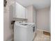 Functional laundry room with a tile floor and updated washer and dryer at 3524 Johnny Cake Ln, Charlotte, NC 28226