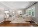 Well-lit living room featuring neutral tones and hardwood flooring at 3524 Johnny Cake Ln, Charlotte, NC 28226