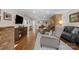 Spacious living room featuring hardwood floors, brick accents, and lots of seating at 3524 Johnny Cake Ln, Charlotte, NC 28226
