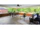 Spacious screened porch with mosaic tile flooring, comfortable seating, and wooded views at 3524 Johnny Cake Ln, Charlotte, NC 28226