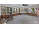 Spacious screened porch with a table and chairs with view of foliage at 3524 Johnny Cake Ln, Charlotte, NC 28226