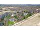 Wide aerial view showcasing multiple homes in a neighborhood adjacent to a golf course and natural landscape at 3730 Club House Ne Dr, Conover, NC 28613