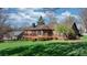 Spacious backyard with a large wooden deck, beautiful landscaping, and a well-maintained lawn at 3730 Club House Ne Dr, Conover, NC 28613