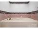 Relaxing bathtub with tile surround, creating a luxurious space for unwinding and rejuvenation at 3730 Club House Ne Dr, Conover, NC 28613