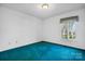 Bright bedroom features light walls, green carpet, and a window that brings in light at 3730 Club House Ne Dr, Conover, NC 28613