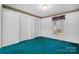 Cozy bedroom with light walls, green carpet, and a window offering natural light at 3730 Club House Ne Dr, Conover, NC 28613