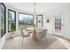 Modern dining area with a chandelier, round table with chairs, and an exterior door to the porch at 3730 Club House Ne Dr, Conover, NC 28613