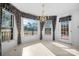 Bright dining area illuminated by a chandelier, with large windows offering backyard views and natural light at 3730 Club House Ne Dr, Conover, NC 28613