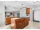 Spacious kitchen featuring a center island with stove and oven, and wooden cabinets, perfect for cooking and entertaining at 3730 Club House Ne Dr, Conover, NC 28613