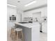 Modern kitchen with white cabinets, an island with barstool seating, and stainless steel appliances at 3730 Club House Ne Dr, Conover, NC 28613