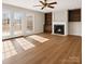 Bright living room with fireplace, built-in shelving, hardwood floors, and French doors to the backyard at 3730 Club House Ne Dr, Conover, NC 28613