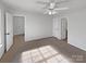 Spacious bedroom with neutral carpet and three doorways, creating an open and accessible space at 3914 Hathaway Hills Dr, Charlotte, NC 28214