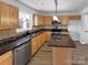 Well-equipped kitchen with stainless steel appliances, central island, and wood cabinets at 3914 Hathaway Hills Dr, Charlotte, NC 28214