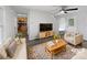 Bright living room featuring modern furnishings, ceiling fan, and wood-look flooring at 3914 Hathaway Hills Dr, Charlotte, NC 28214