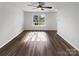 Bright living room featuring hardwood floors, a ceiling fan and a view of the neighborhood at 3914 Hathaway Hills Dr, Charlotte, NC 28214