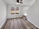 Bright living room featuring hardwood floors, a ceiling fan and a view from the large window at 3914 Hathaway Hills Dr, Charlotte, NC 28214
