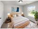 Staged main bedroom with a neutral palette, stylish decor, and natural light at 3914 Hathaway Hills Dr, Charlotte, NC 28214