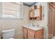 Cozy bathroom with modern vanity, tiled floor and tree-patterned wallpaper at 409 Cardinal Dr, Newton, NC 28658