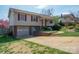 Charming two-story home boasts a brick facade, attached garage, and a well-manicured front yard at 409 Cardinal Dr, Newton, NC 28658