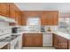 Functional kitchen featuring wood cabinetry, modern appliances, and bright, subway tile backsplash at 409 Cardinal Dr, Newton, NC 28658