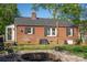 The backyard has a brick home, an outdoor fire pit, and well-maintained landscaping at 412 W D Ave, Salisbury, NC 28144