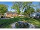 Landscaped backyard with a charming pond, fire pit area, and lush greenery at 412 W D Ave, Salisbury, NC 28144