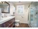 Bright bathroom features a sink, toilet, shower and a large window at 412 W D Ave, Salisbury, NC 28144
