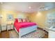 Bright bedroom featuring a bed, ceiling fan, a bedside table, and large window at 412 W D Ave, Salisbury, NC 28144