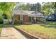 Charming brick home with a welcoming front porch and well-manicured lawn and driveway at 412 W D Ave, Salisbury, NC 28144
