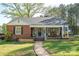 Charming brick home with inviting front porch and colorful walkway, landscaped for curb appeal at 412 W D Ave, Salisbury, NC 28144