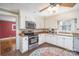 Cozy kitchen features white cabinetry, stainless steel appliances, and a colorful decorative rug at 412 W D Ave, Salisbury, NC 28144