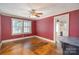 View of a living room with hardwood floors, a large window, and access to the kitchen at 412 W D Ave, Salisbury, NC 28144
