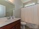 Well-maintained bathroom offers a single sink vanity and a shower with a white curtain at 4425 Marlay Park, Indian Trail, NC 28079